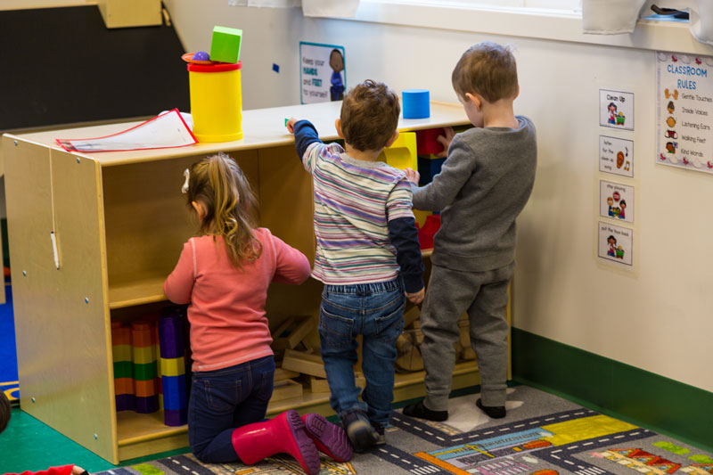 Image of children helping clean their classroom