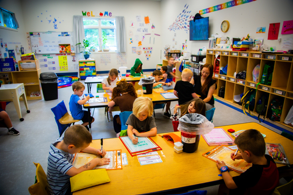 Image of children helping clean their classroom