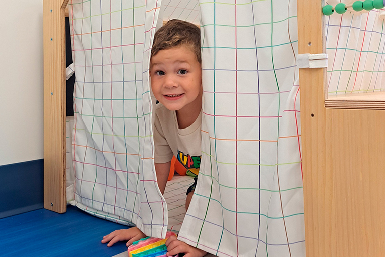 Image of a child in an indoor play fort