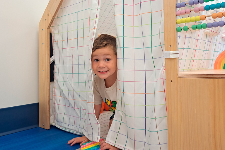 Image of child in an indoor play fort
